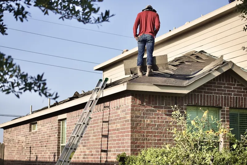 Professional roofer working on a residential roof in Rock Island-Samuels Avenue